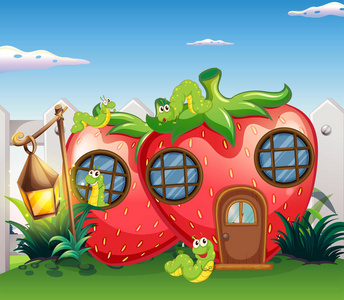 毛毛虫在花园里的草莓房子卡通毛毛虫与书志向概念和志向想法作为毛