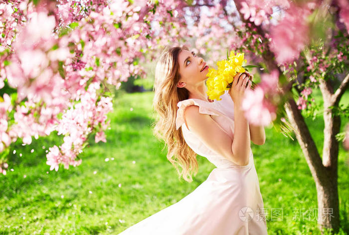 春天的风格 美丽的年轻的黑发妇女穿着漂亮的春季礼服与一束郁金香 美丽的春天花园 时尚春夏写真照片 正版商用图片0epnne 摄图新视界