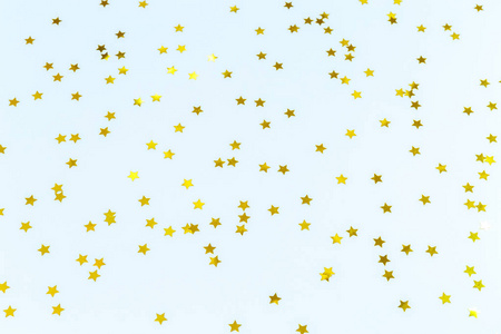 金色的星洒在蓝色。节日背景。名人