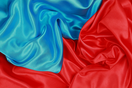 蓝色和红色丝绸布的波浪抽象背景