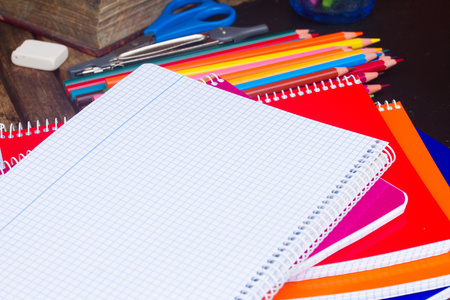 本空白笔记本和彩色铅笔在黑板上套