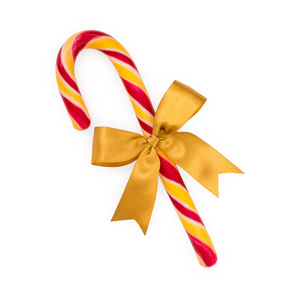 白色背景下的金色蝴蝶结的圣诞糖果手杖