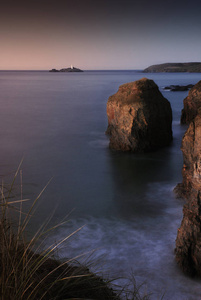 在 Gwithian 海滩的悬崖边缘, 美丽的海长曝光。在距离是 Godrevy 轻的房子, 康沃尔, 英国