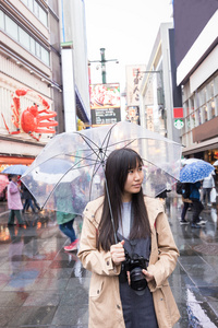 在下雨天站在日本的亚洲女性图片