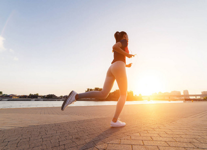 年轻女性赛跑者在日落时慢跑, 日出时间