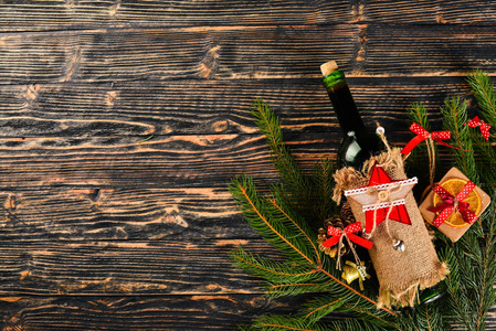 圣诞餐桌服务, 和一瓶酒。新年。圣诞树和圣诞树装饰品。在木制背景上。文本的可用空间