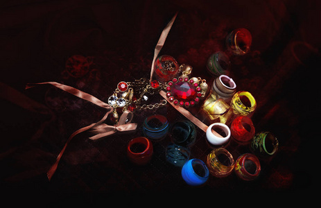 许多五颜六色的玻璃戒指和 neklace 在一个深红色的布