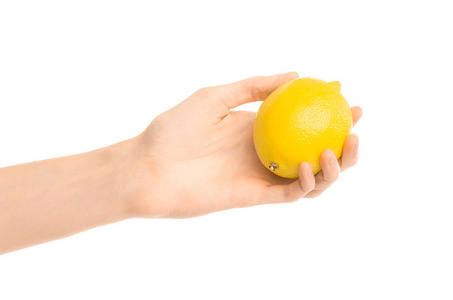 健康的饮食和饮食主题 人类的手，握著孤立在工作室里的白色背景上的黄色柠檬
