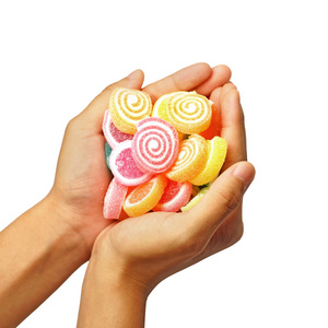 儿童手抓住果冻甜糖果上白色孤立照片