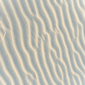 在夏天的海滩砂模式的特写。海滩背景。顶视图