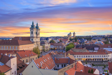 少数民族教堂的美丽的看法和 Eger, 匈牙利的城市全景, 在日落