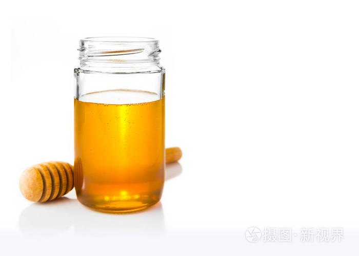 金黄 heney 在清楚的玻璃罐子与木蜂蜜北斗在