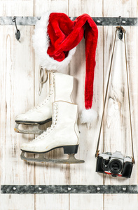 红色的圣诞老人帽子，怀旧照片相机和白色溜冰鞋