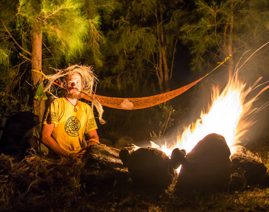 火岩石几个坐着的岩石海滩上的篝火照片