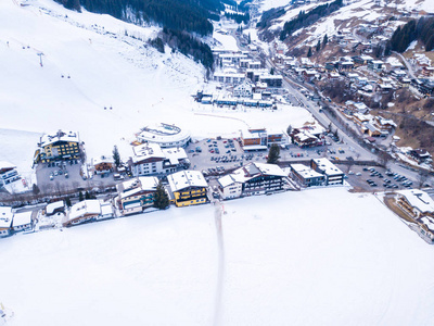 滑雪胜地冬天镇或村庄的鸟瞰在阿尔卑斯与小房子, 室外水池滑雪升降机和倾斜