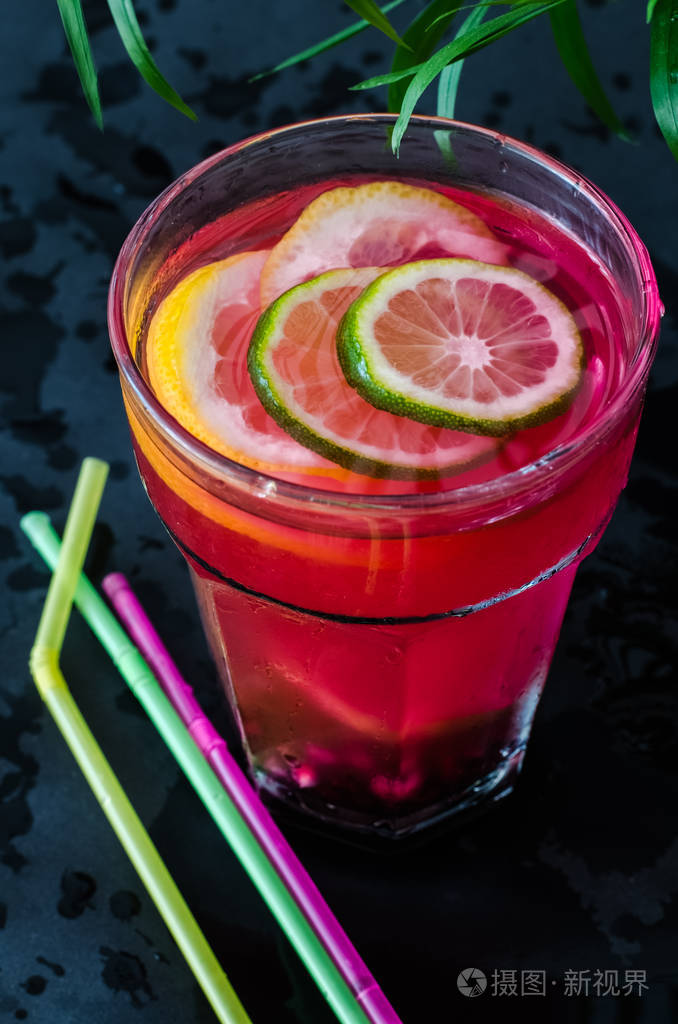 冷果鸡尾酒, 石榴籽和 citruses 片, 深色背景