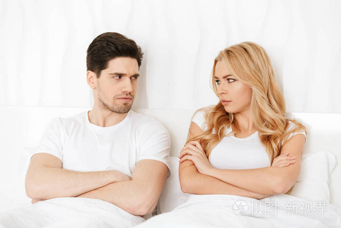 愤怒的情侣躺在家里的床上吵架