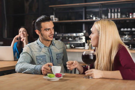 快乐的年轻夫妇喝咖啡在咖啡馆