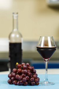 一簇红葡萄和一杯干红葡萄酒