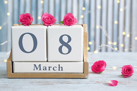木块日历和花在桌上。国际妇女节庆典