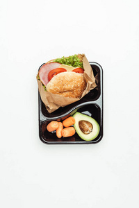 午餐盒的顶部视图与汉堡和蔬菜的白色隔离
