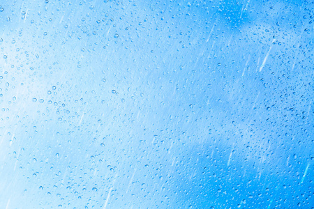 蓝色玻璃背景上的雨滴