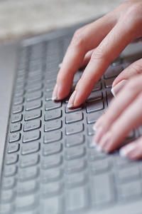 女性的手放在笔记本键盘特写