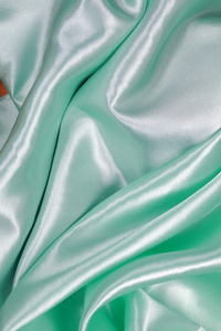 浅绿色绸缎布波浪褶纹理背景