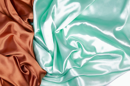 布朗和光绿色丝缎布的波浪褶皱纹理 bac照片