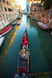 威尼斯船夫的小船通过绿色运河水域, 意大利照片为您