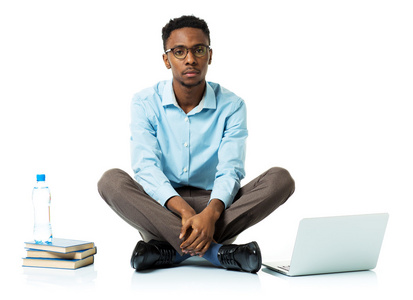 严重的非洲裔美国大学学生用笔记本电脑，书籍和