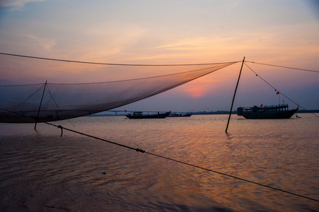 平静的景象的渔网对紫色日落