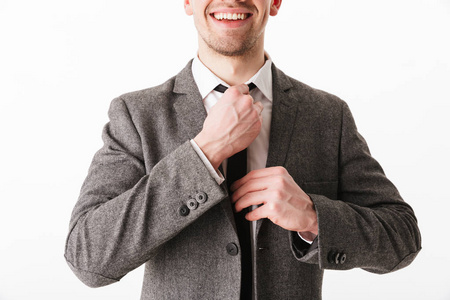 被裁剪的微笑的商业人的形象在夹克改正领带