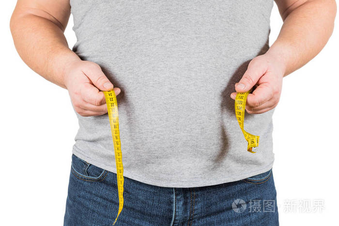 厚的成熟的人测量腹部黄色测量磁带被隔绝在白色背景上