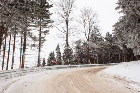 白雪皑皑的山路。冰的风险。在白雪皑皑的树林中的路径