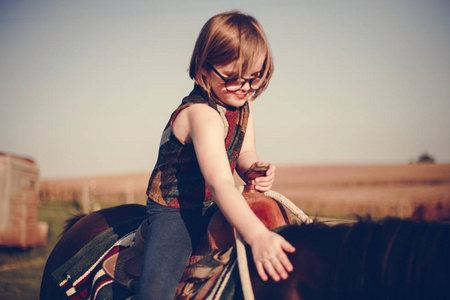 小女孩骑着一匹马