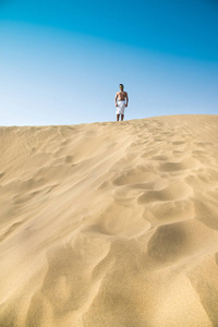 沙漠中的人漫步在沙丘上