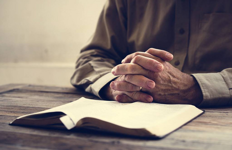 在基督教信仰圣经的手祈祷照片