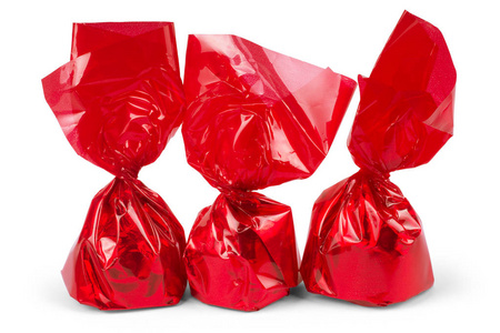 明亮的糖果一块糖果或咳嗽药水裹在明亮的红色玻璃纸照片