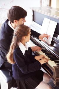 老师训练扮演钢琴的女孩