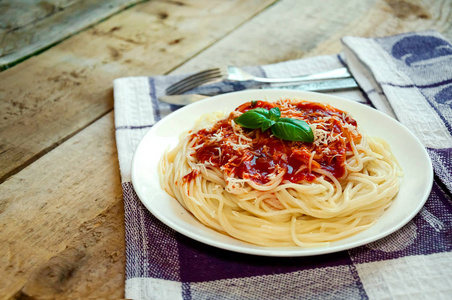 意大利面配番茄酱, 芝士和罗勒在木桌上。意大利传统食品