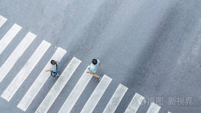 从顶部横向看人们走在街道行人十字路口的城市街道鸟瞰图