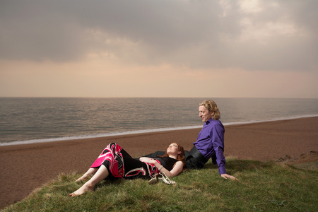 坐在海滩旁边的一对夫妇照片