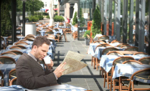 休息的商人在餐馆喝咖啡看报纸