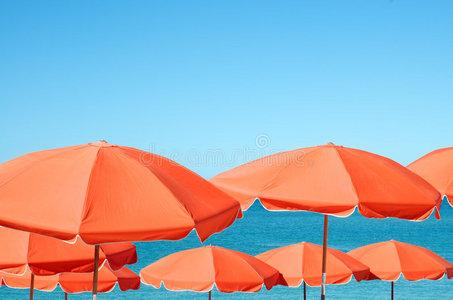 沙滩伞与热带岛屿上的躺椅沙滩伞坐在沙滩椅上的情侣的顶部视图在沙