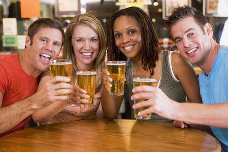 一群年轻的朋友在酒吧里向镜头敬酒
