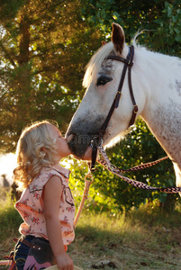 小女孩亲吻小马。