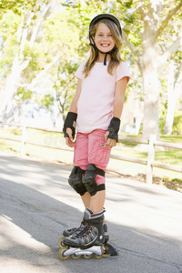 穿着直排溜冰鞋在户外微笑的年轻女孩