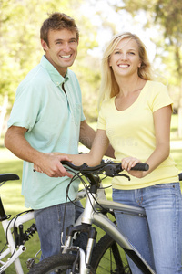 公园里骑自行车的年轻夫妇