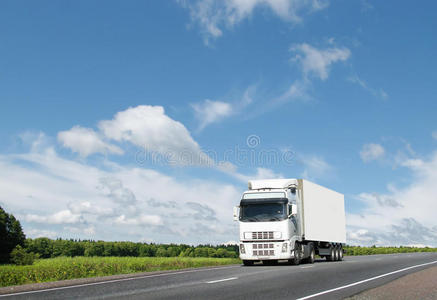 蓝天下乡村公路上的白色卡车图片